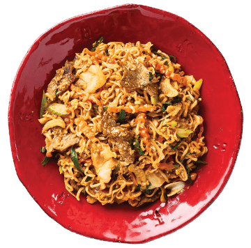 Beef ramen with noodles, beef pieces, and vegetables in a red bowl