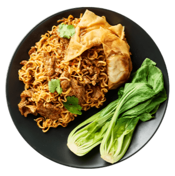 Plate of fried noodles with meat, crispy wonton chips, cilantro, and bok choy on a dark dish.
